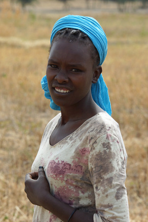 GREAT RIFT VALLEY, ETHIOPIA - NOVEMBER 16, 2014: Young Ethiopian woman on a field on November 23, 2014 in the Great Rift Valley, Ethiopia, Africaのeditorial素材