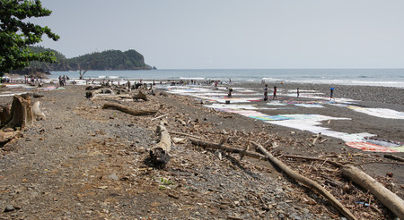 PRAIA MESSIA ALVES, SAO TOME - JANUARY 29, 2017: Women washing clothes on Praia Messia Alves on January 29, 2017 in Sao Tome, Africaのeditorial素材