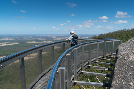 MOUNT BARKER, AUSTRALIA - FEBRUARY 2, 2018: Tourist standing on the amazing lookout on Castle Rock, highlight within the Porongurup National Park close to Albany on February 2, 2018 in Western Australiaのeditorial素材
