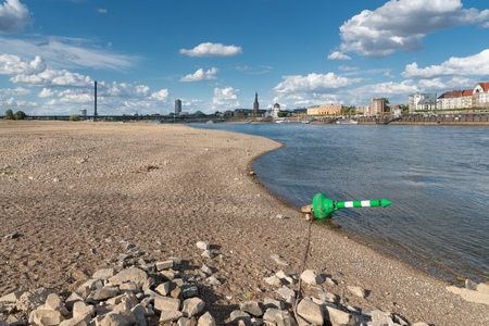 DUESSELDORF, GERMANY - AUGUST 11, 2018: Drought in Germany, low water of the Rhine river with the cityscape of Duesseldorf on August 11, 2018 in Germanyのeditorial素材