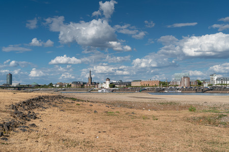 DUESSELDORF, GERMANY - AUGUST 10, 2018: Drought in Germany, low water of the Rhine river with the cityscape of Duesseldorf on August 10, 2018 in Germanyのeditorial素材