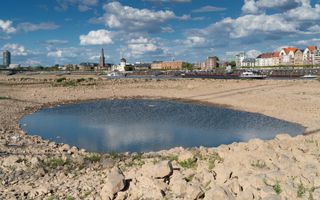 DUESSELDORF, GERMANY - AUGUST 10, 2018: Drought in Germany, low water of the Rhine river with the cityscape of Duesseldorf on August 10, 2018 in Germanyのeditorial素材