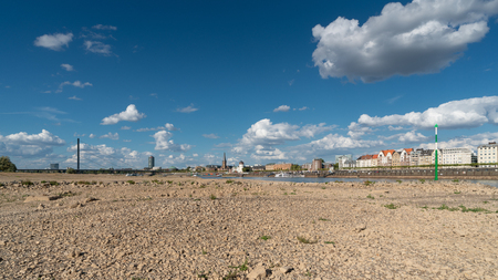 DUESSELDORF, GERMANY - AUGUST 11, 2018: Drought in Germany, low water of the Rhine river with the cityscape of Duesseldorf on August 11, 2018 in Germanyのeditorial素材