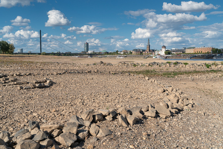 DUESSELDORF, GERMANY - AUGUST 10, 2018: Drought in Germany, low water of the Rhine river with the cityscape of Duesseldorf on August 10, 2018 in Germanyのeditorial素材