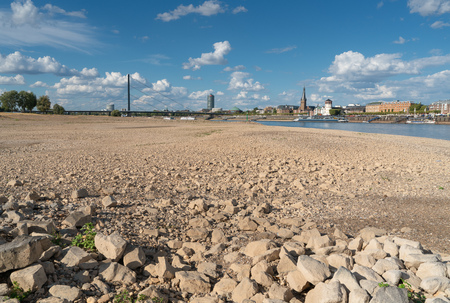 DUESSELDORF, GERMANY - AUGUST 11, 2018: Drought in Germany, low water of the Rhine river with the cityscape of Duesseldorf on August 11, 2018 in Germanyのeditorial素材