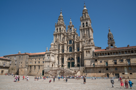 SANTIAGO DE COMPOSTELA, SPAIN - SEPTEMBER 1, 2018: Pilgrims in front of the cathedral of Santiago de Compostela, beautiful building with blue sky on September 1, 2018 in Galicia, Spainのeditorial素材