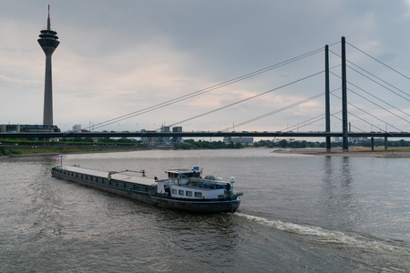 DUSSELDORF, GERMANY - JULY 21, 2018: Inland navigation vessel passing Dusseldorf on the Rhine river on July 21, 2018 in Germany, Europeのeditorial素材