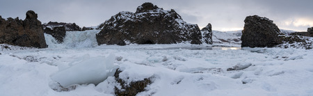 Frozen Hjalparfoss waterfall on a cloudy morning, winter in Iceland, Europeの写真素材