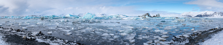 Panoramic view of the glacier lagoon Joekulsarlon with icebergs and in the background the glacier, winter in Iceland, Europeの写真素材