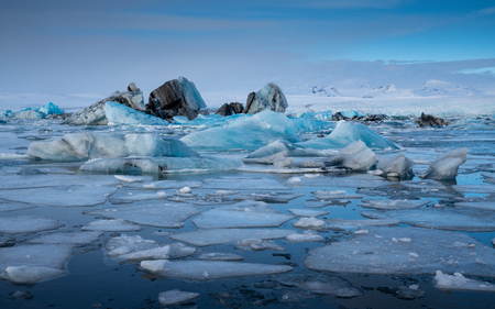 Panoramic view of the glacier lagoon Joekulsarlon with icebergs and in the background the glacier, winter in Iceland, Europeの写真素材