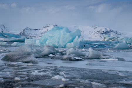 Panoramic view of the glacier lagoon Joekulsarlon with icebergs and in the background the glacier, winter in Iceland, Europeの写真素材