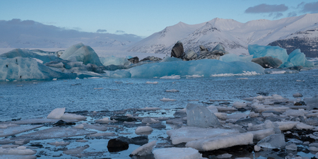 Panoramic view of the glacier lagoon Joekulsarlon with icebergs and in the background the glacier, winter in Iceland, Europeの写真素材