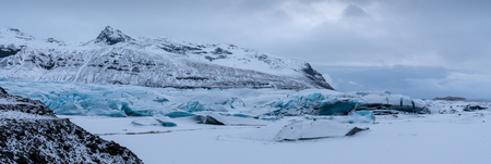Panoramic image of the snow-coverd glacier Svinafellsjoekull on a winter day after snowfall, Iceland, Europeの写真素材