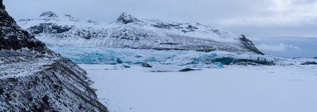 Panoramic image of the snow-coverd glacier Svinafellsjoekull on a winter day after snowfall,...