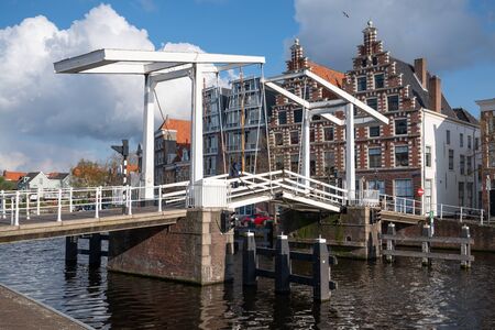 HAARLEM, NETHERLANDS - APRIL 13, 2019: City center with old bridge crossing a creek on April 13, 2019 in Haarlem, Netherlandsのeditorial素材
