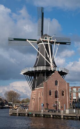 HAARLEM, NETHERLANDS - APRIL 13, 2019: Old windmill in the city center of Haarlem on April 13, 2019 in the Netherlandsのeditorial素材