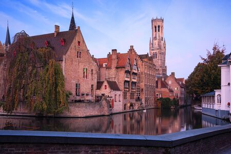 Early morning mood an the channels of Bruges with old buildings reflecting in the water, Belgiumの写真素材