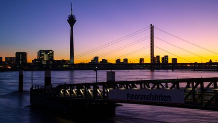 Colorful sunset on the Rhine river with the cityscape of Dusseldorf in the background, Germanyの写真素材