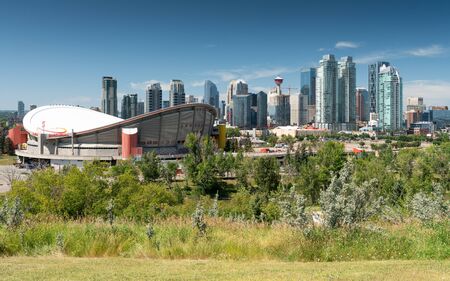 CALGARY, CANADA - AUGUST 5, 2019: Panoramic image of the skyline of Calgary with the Saddledom in the foreground on August 5, 2019 in Alberta, Canadaのeditorial素材