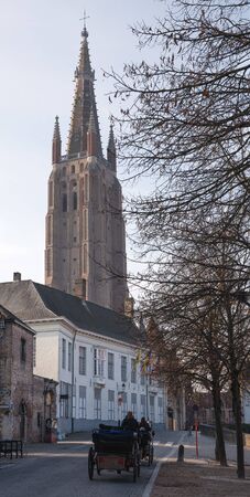 BRUGES, BELGIUM - OCTOBER 31, 2019: Street onto the church of our Lady, historic city of Bruges on October 31, 2019 in Belgiumのeditorial素材