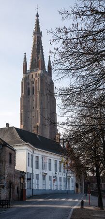 BRUGES, BELGIUM - OCTOBER 31, 2019: Street onto the church of our Lady, historic city of Bruges on October 31, 2019 in Belgiumのeditorial素材