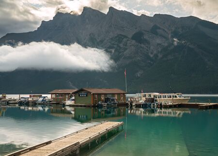 BANFF, CANADA - AUGUST 13, 2019: Panoramic image of Lake Minnewanka with early morning mood on August 13, 2019 in Banff National Park, Alberta, Canadaのeditorial素材