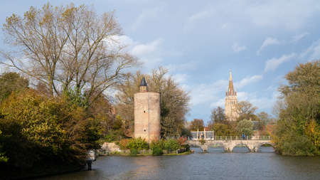 BRUGES, BELGIUM - NOVEMBER 2, 2019: Panoramic image of the Minnewaterpark in Bruges with historic buildings, trees and idyllic canals on November 2, 2019 in Flanders, Belgiumのeditorial素材