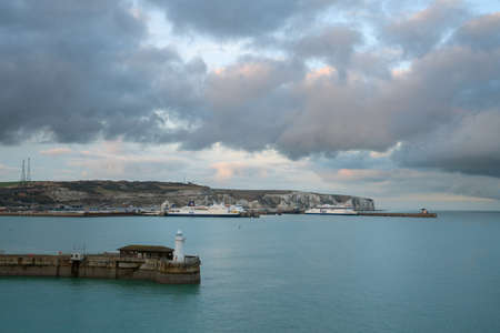 DOVER, GREAT BRITAIN - FEBRUARY 5, 2020: Panoramic image of the ferry terminal of Dover with the white cliffs in the background at sunset on February 5, 2020 in Great Britainのeditorial素材
