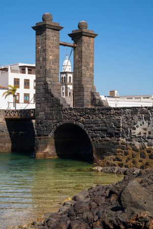 Bridge to the historic fort of Arrecife on a sunny day with blue sky, Lanzarote, Spainの写真素材