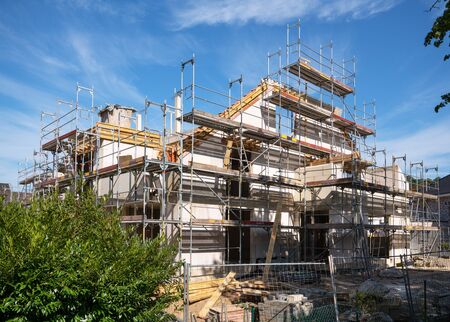 Construction business, framing of multi-family house against blue skyの写真素材