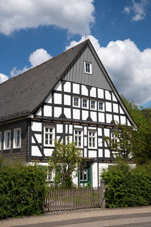 Image of an old half-timbered house against sky in summertime, Oberkirchen, Schmallenberg, Sauerland, Germanyのeditorial素材