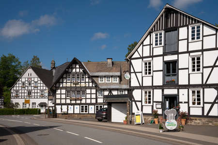 SCHMALLENBERG, GERMANY - JUNE 12, 2020: Image of old half-timbered houses against blue sky in summertime on June 12, 2020 in Oberkirchen, Schmallenberg, Sauerland, Germanyのeditorial素材