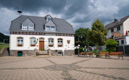 ENKIRCH, GERMANY - JUNE 20, 2020: Panoramic image of the tourist information office of the Moselle village Enkirch against dramatic sky on June 20, 2020 in Germanyのeditorial素材