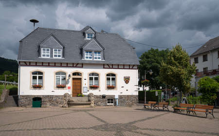 ENKIRCH, GERMANY - JUNE 20, 2020: Panoramic image of the tourist information office of the Moselle village Enkirch against dramatic sky on June 20, 2020 in Germanyのeditorial素材