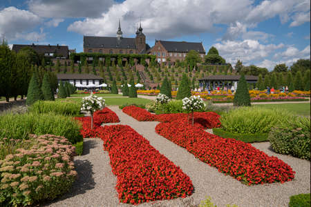 KAMP-LINTFORT, GERMANY - AUGUST 22, 2020: Panoramic image of monastery Kamp with blooming flowers against cloudy sky on August 22, 2020 in Germanyのeditorial素材