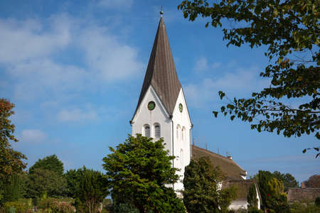 Old church of Nebel against blue sky, Amrum, Germanyの写真素材