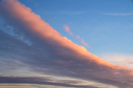 Early morning sky with pastel-colored cloudsの写真素材