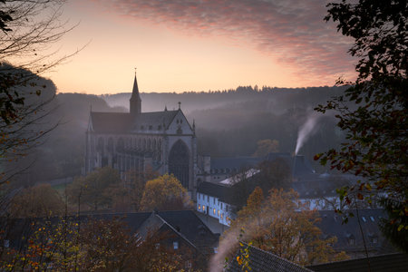 ODENTHAL, GERMANY - NOVEMBER 10, 2020: Panoramic image of the Altenberg cathedral in early morning light on a foggy day on November 10, 2020 in Germanyのeditorial素材