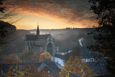 ODENTHAL, GERMANY - NOVEMBER 10, 2020: Panoramic image of the Altenberg cathedral in early morning light on a foggy day on November 10, 2020 in Germanyのeditorial素材