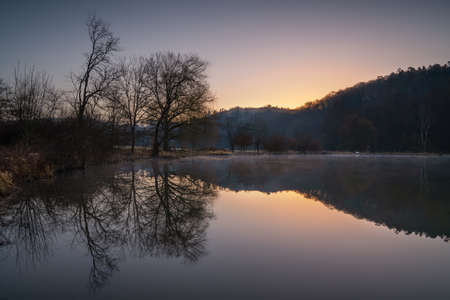 Fishpond close to Lindlar with water reflection during early morning mood, Bergisches Land, Germanyの写真素材