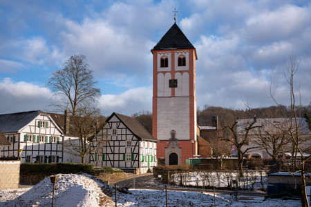 ODENTHAL, GERMANY - FEBRUARY 10, 2021: Center of village Odenthal with parish church and old buildings on a winter day on February 10, 2021 in Germanyのeditorial素材