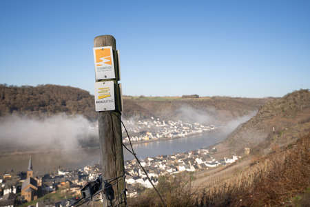 ALKEN, GERMANY - FEBRUARY 27, 2022: Long distance hiking trail Moselsteig with focus on the typical waymark on February 27, 2022 in Alken, Germanyのeditorial素材