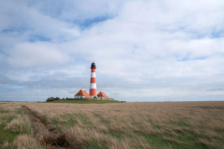 Panoramic image of Westerhever lighthouse against sky, North Frisia, Germanyの写真素材
