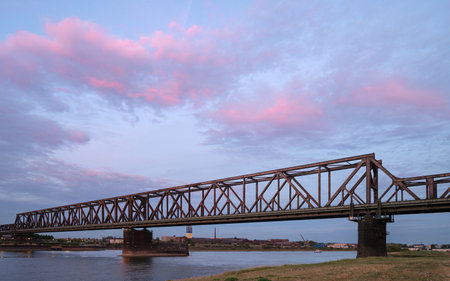 DUISBURG, GERMANY - JULY 13, 2022: Old bridge crossing the Rhine river during sunset on July 13, 2022 in Duisburg, Germanyのeditorial素材