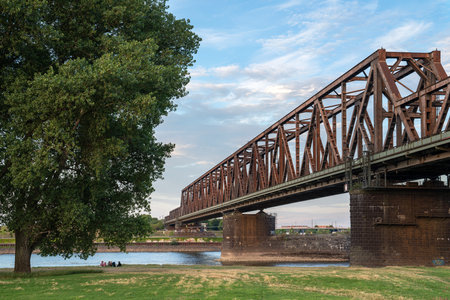 DUISBURG, GERMANY - JULY 13, 2022: Old bridge crossing the Rhine river during sunset on July 13, 2022 in Duisburg, Germanyのeditorial素材