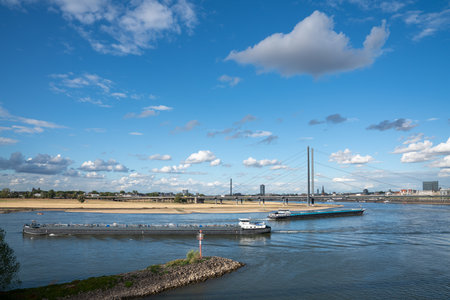 DUSSELDORF, GERMANY - SEPTEMBER 8, 2022: Inland navigation vessels passing Dusseldorf on the Rhine river on September 8, 2022 in Germany, Europeのeditorial素材