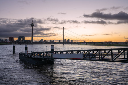 DUSSELDORF, GERMANY - DECEMBER 25, 2020: Colorful sunset on the Rhine river with the cityscape of Dusseldorf in the background on December 25, 2020 in Germanyのeditorial素材