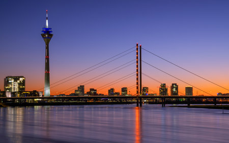 Colorful sunset on the Rhine river with the cityscape of Dusseldorf in the background, Germanyの写真素材