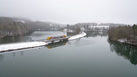 Panoramic image of Bigge lake on a foggy winter day, Sauerland, Germanyの写真素材