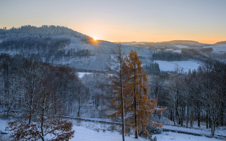 Panoramic image of winter landscape during sunrise, Schmallenberg, Sauerland, Germanyの写真素材